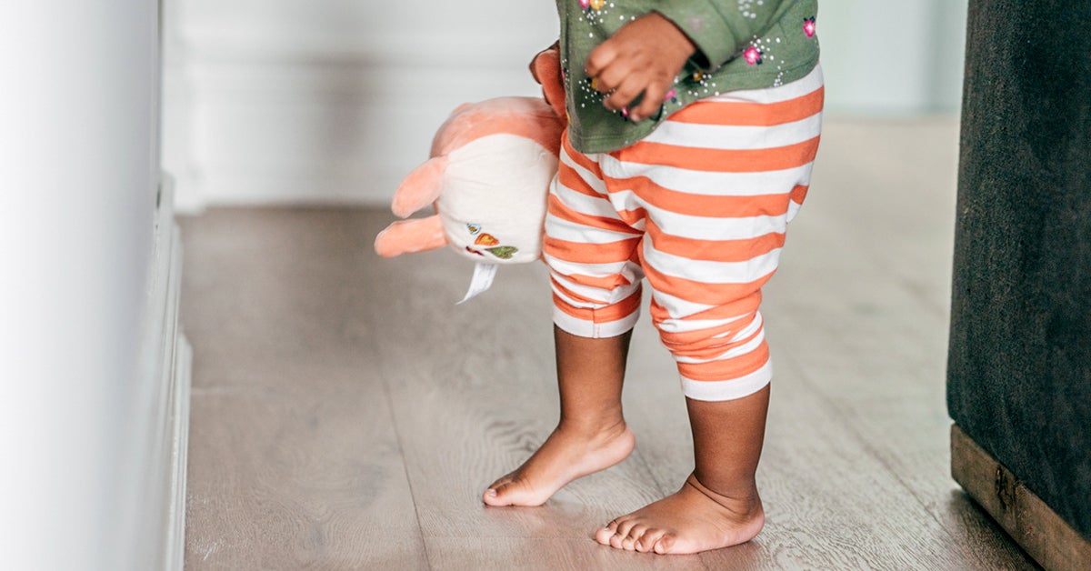 young child walking on tiptoes