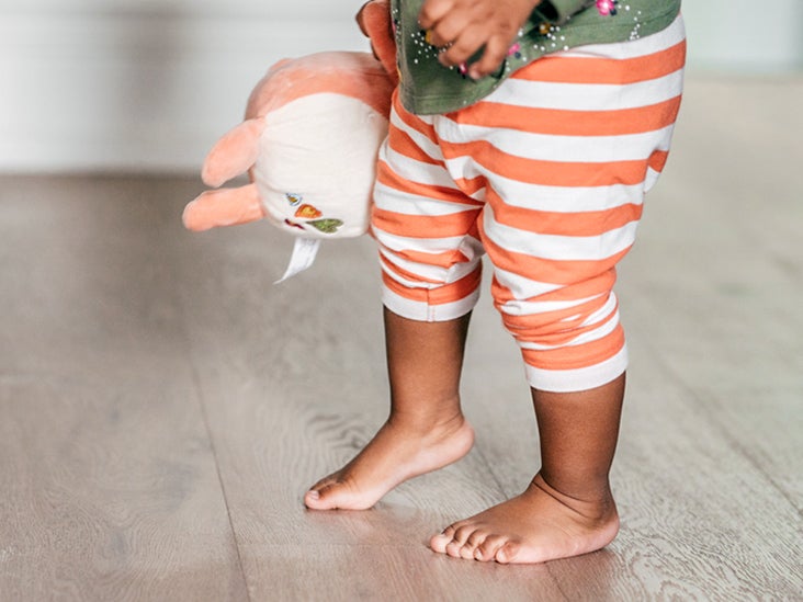 infant walking on tiptoes