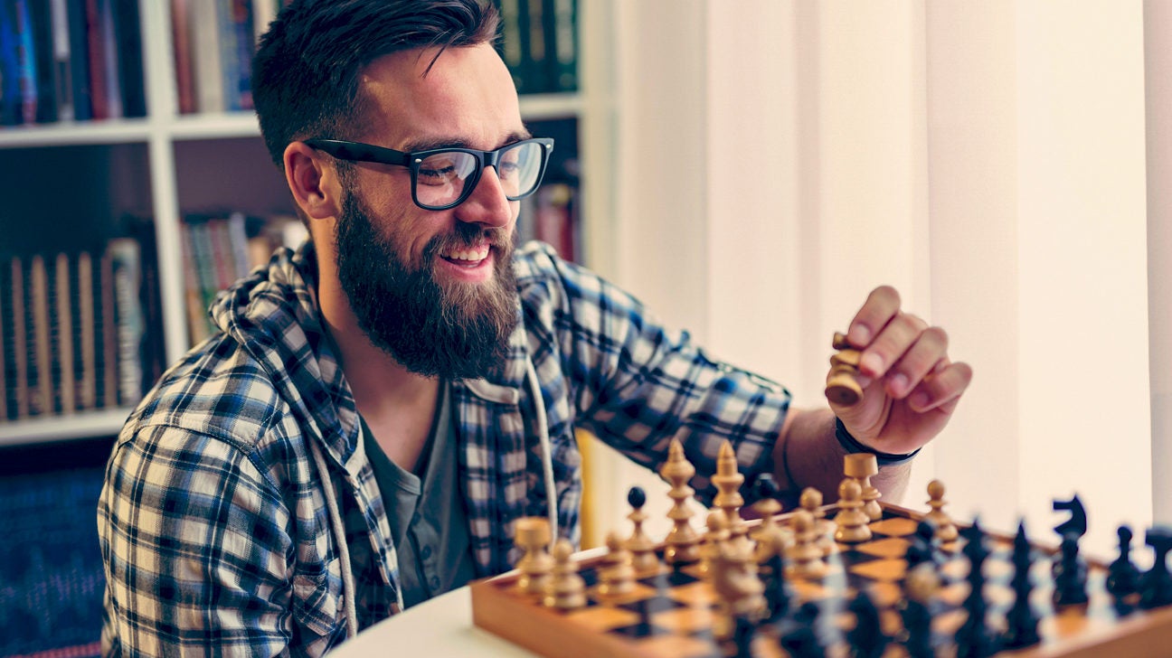 Focused woman thinking about next move and playing chess · Free Stock Photo