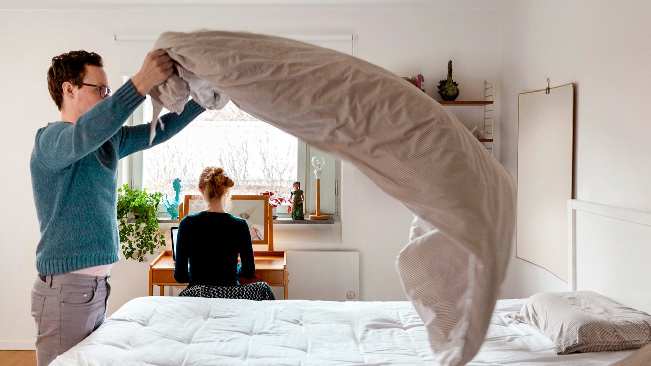 https://post.healthline.com/wp-content/uploads/2019/09/Man-making-bed-while-woman-working-at-table-in-bedroom-1296x728-header-1296x728.jpg