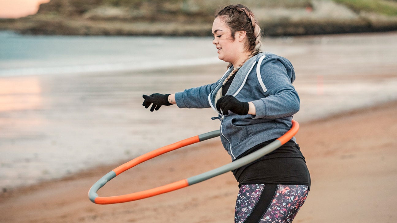 https://post.healthline.com/wp-content/uploads/2019/09/Young-Woman-Using-a-Weighted-Hula-Hoop-1296x728-header-1296x728.jpg