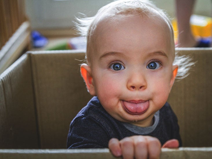 8 week old baby sticking tongue out