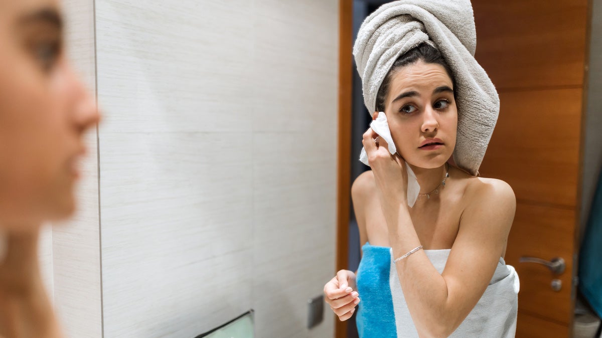 Beautiful young woman's back after shower with red towel Stock Photo