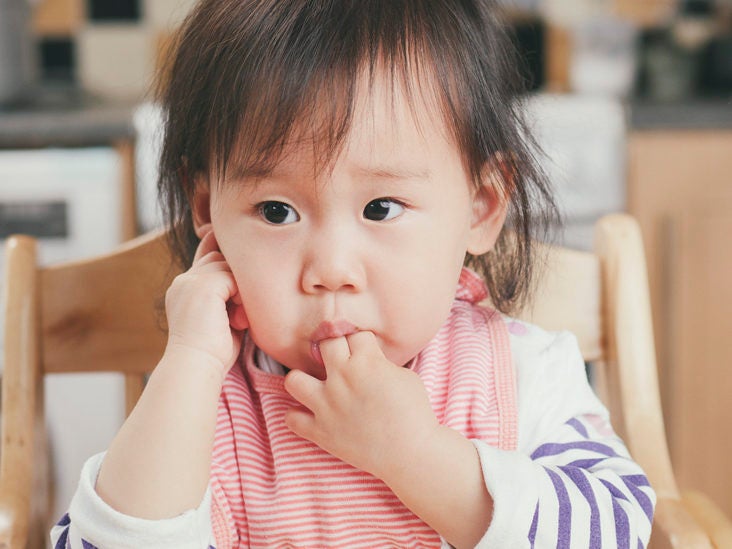 baby keeping hands in mouth