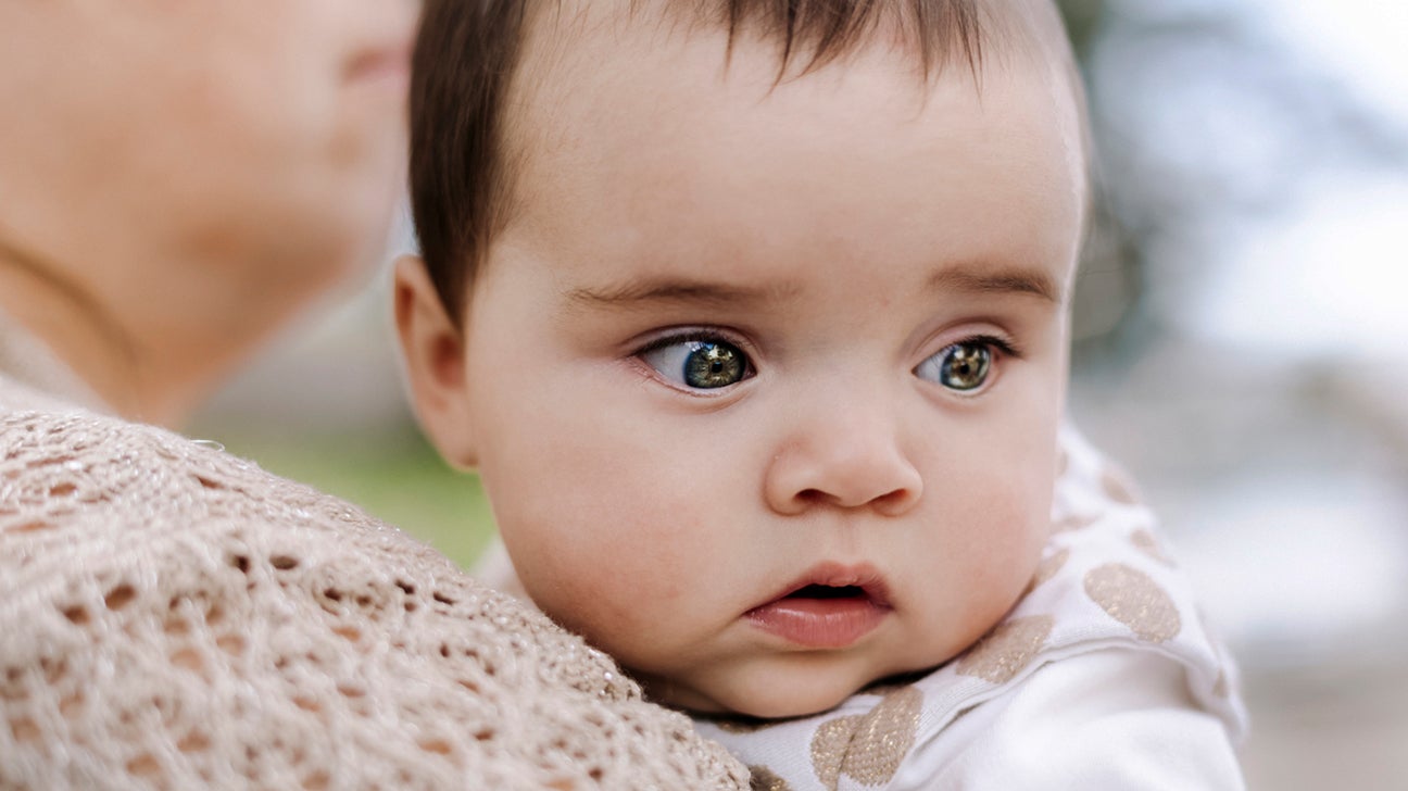 blonde african american man with blue eyes looking at camera