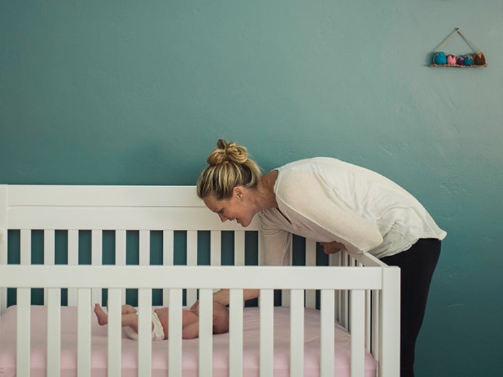 mom sleeping in nursery