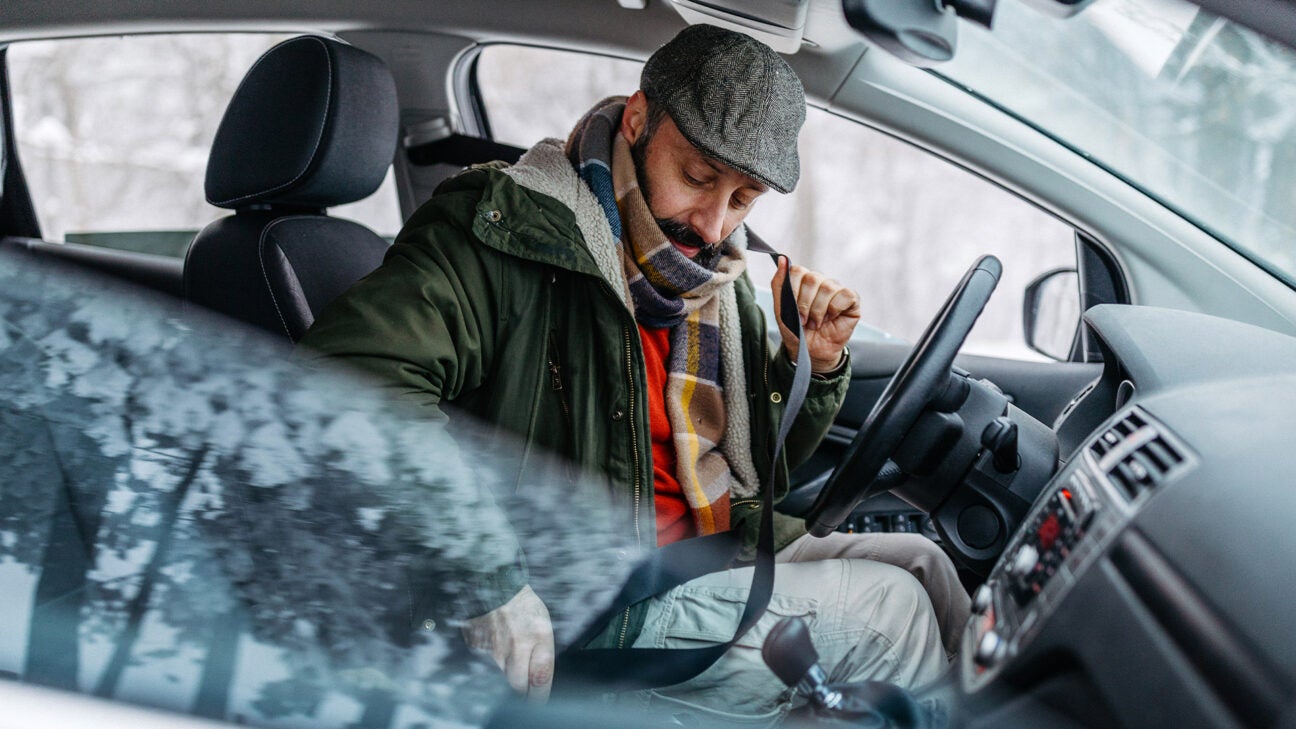 Driver finds man hiding in backseat of her car under coat on highway