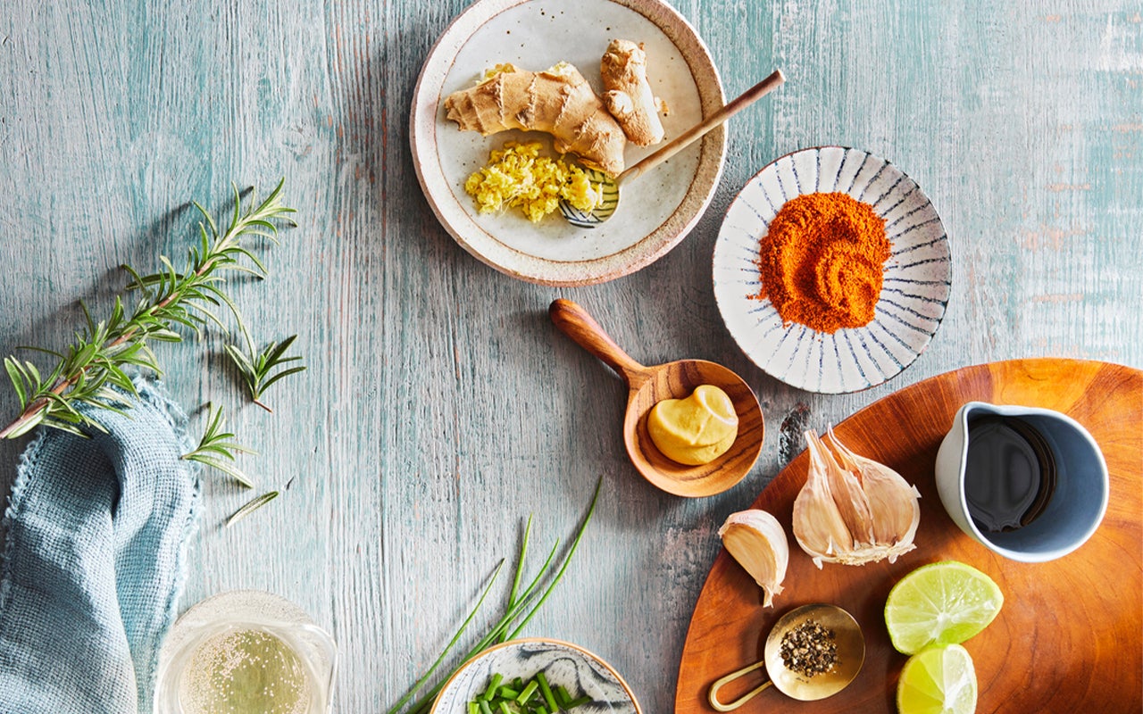 Composition of small spoons full of spices and condiments for cooking on a  black background Stock Photo