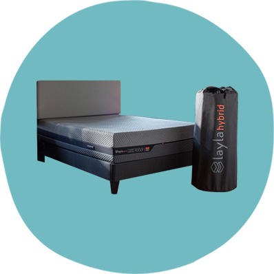 Side view of Layla Hybrid Mattress on bed frame with mattress bag