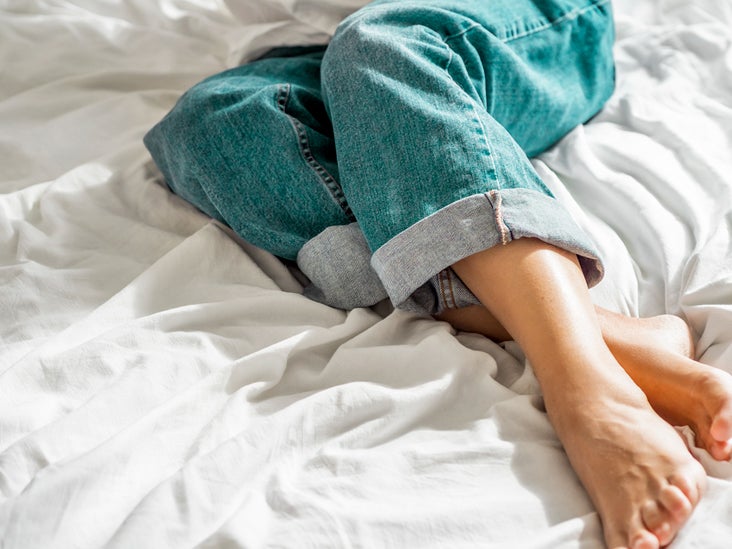 Female in classic blue jeans on crumpled bed sheet 732x549 thumbnail