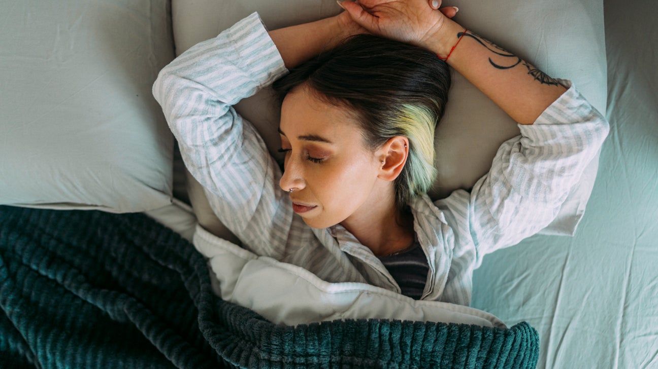 Sleeping with pillow between legs hi-res stock photography and