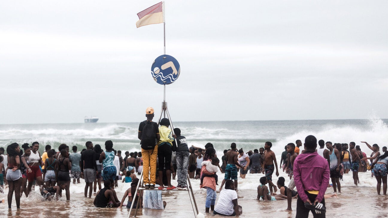 People crowd a beach in South Africa.