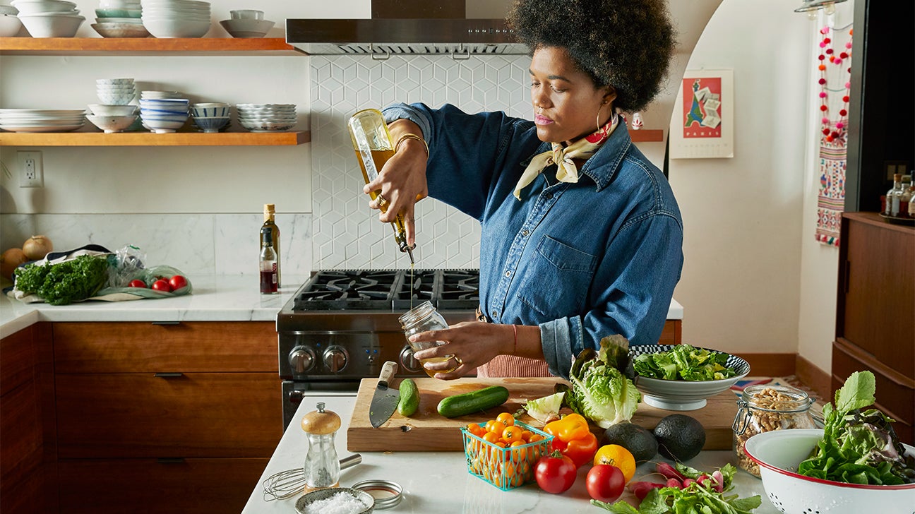 Woman prepares vegetables in kitchen