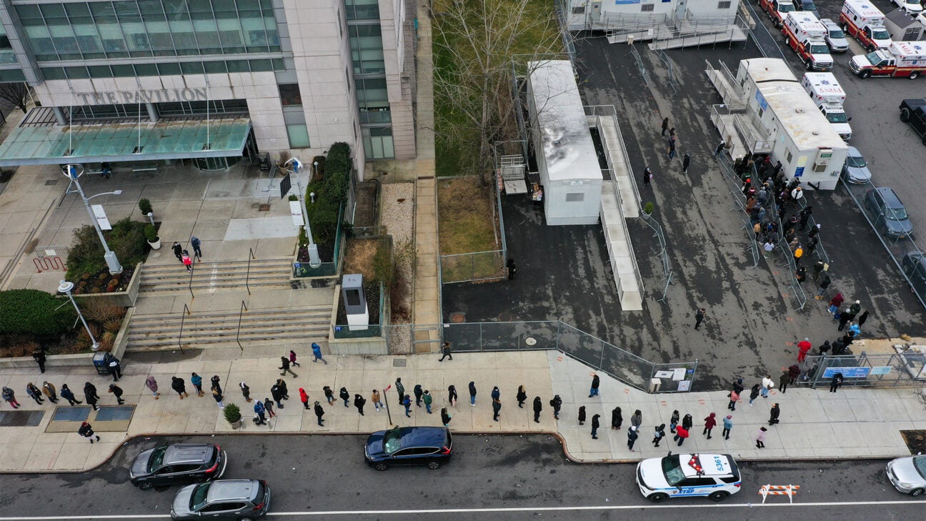 A long line of people is seen outside a hospital as they wait for a COVID-19 test. 