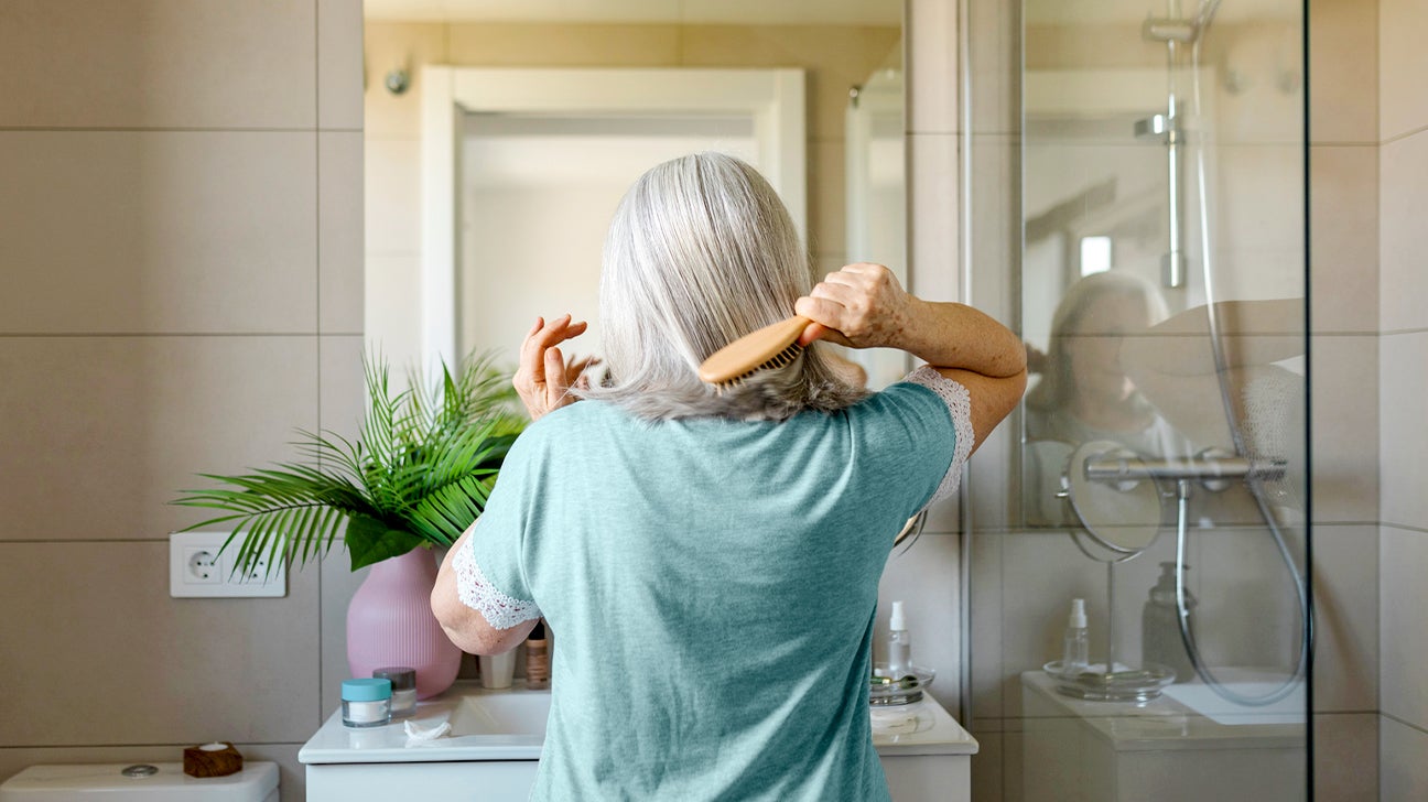 https://post.healthline.com/wp-content/uploads/2022/02/Back-view-of-a-Mature-woman-brushing-her-hair-header.jpg