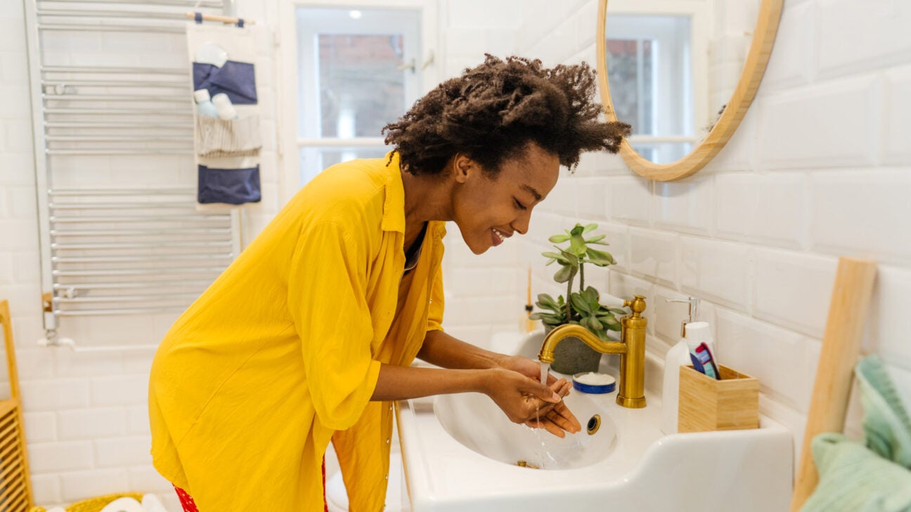 https://post.healthline.com/wp-content/uploads/2022/03/young_african_american_woman_washing_face_in_bathroom-1296x728-header-1296x729.jpg