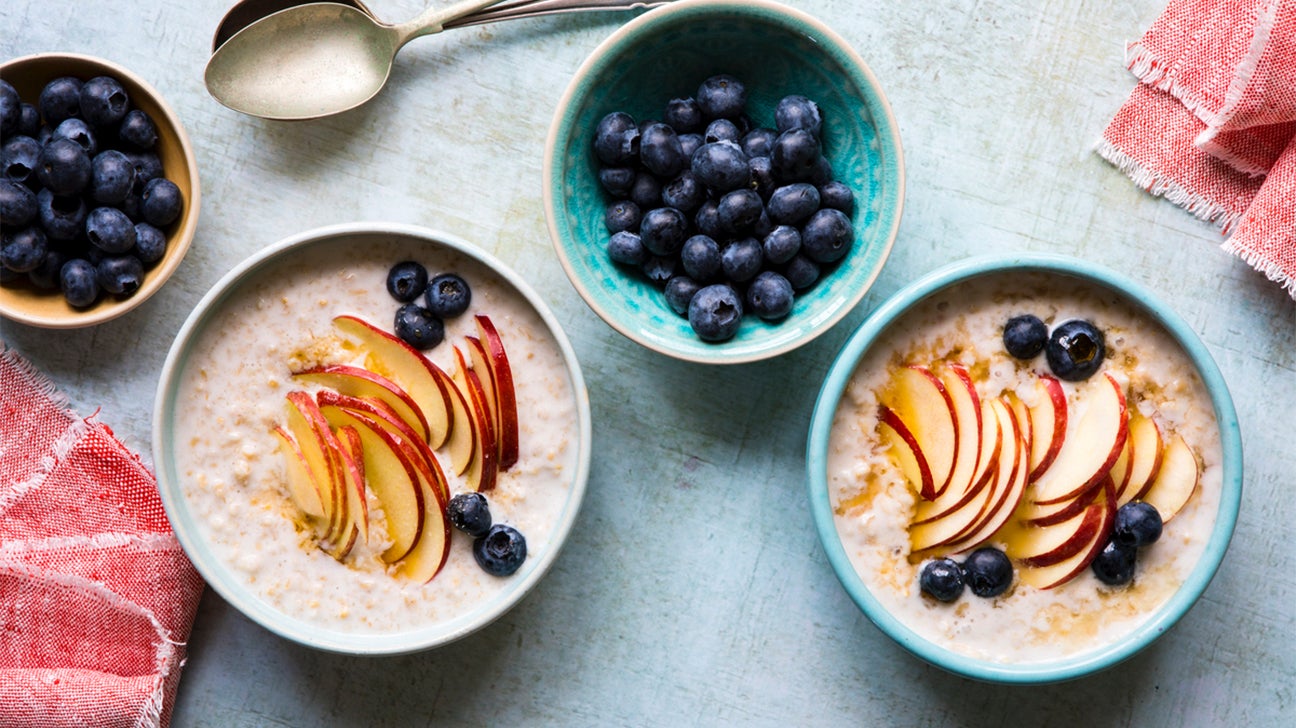 Bowls of oatmeal with blueberries and apple slices