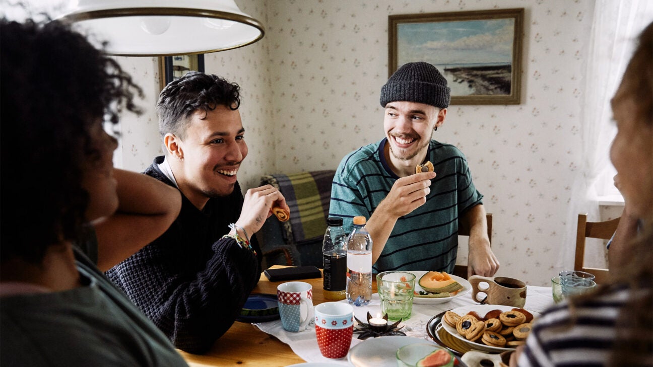 Friends share a meal around a table.