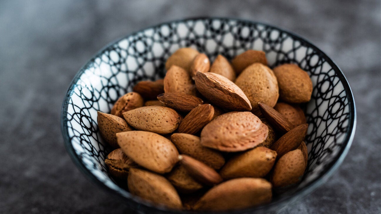 More than a dozen almonds in a bowl