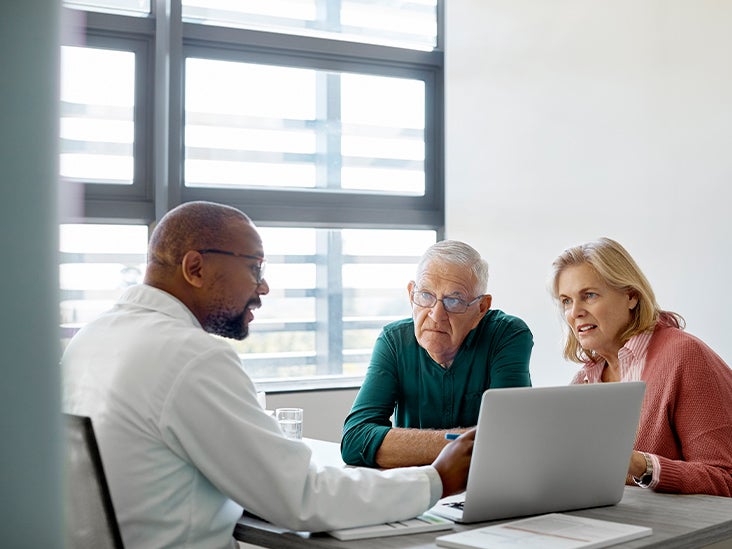 An older couple listens to a medical professional