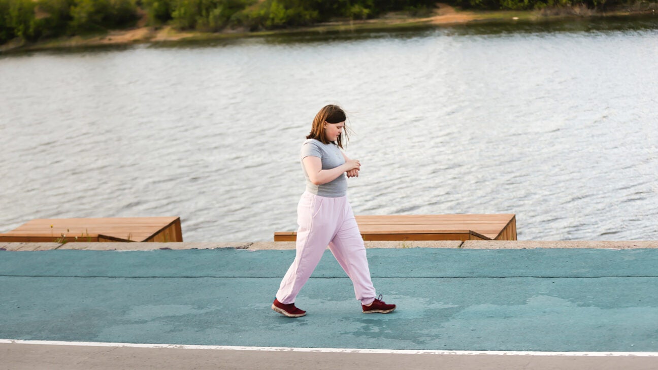 Teen girl walking on a track.