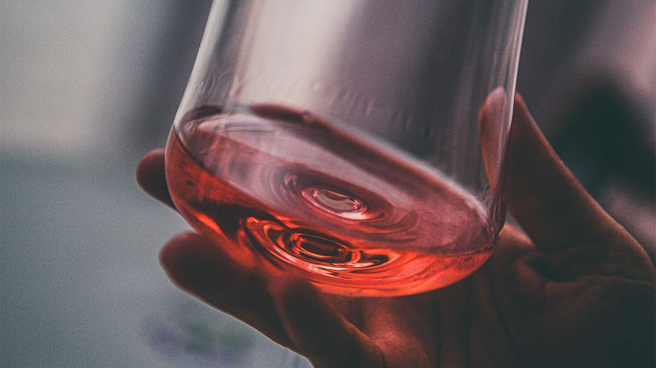 https://post.healthline.com/wp-content/uploads/2022/12/close-up-hand-holding-glass-of-wine-1296x728-header.jpg