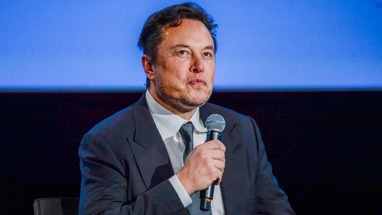 Elon Musk is seen talking on stage.