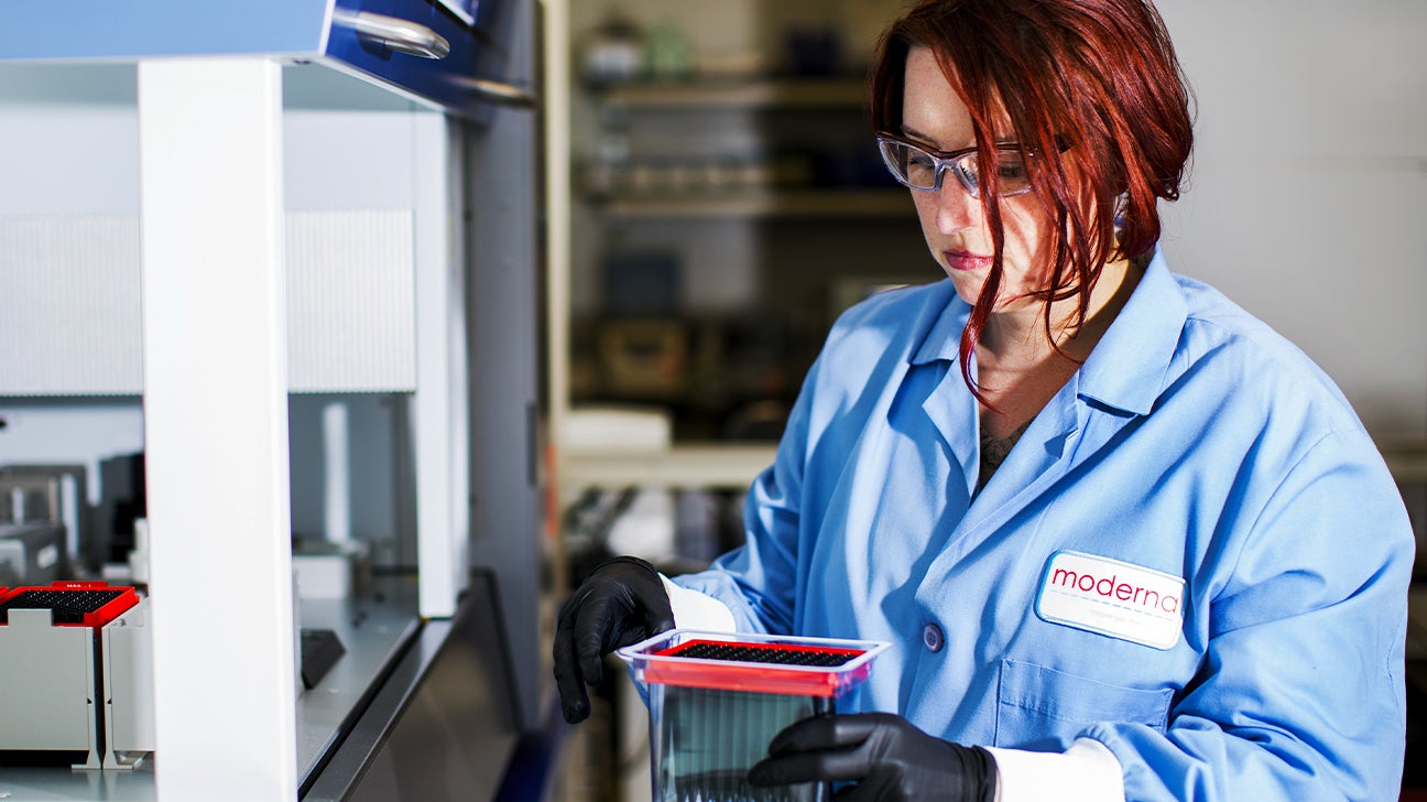 A Moderna researcher studies some test tubes