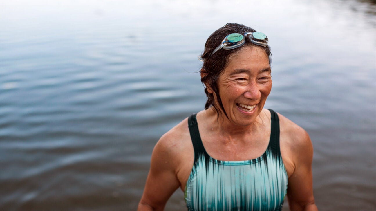 Woman in open body of water in swimsuit.