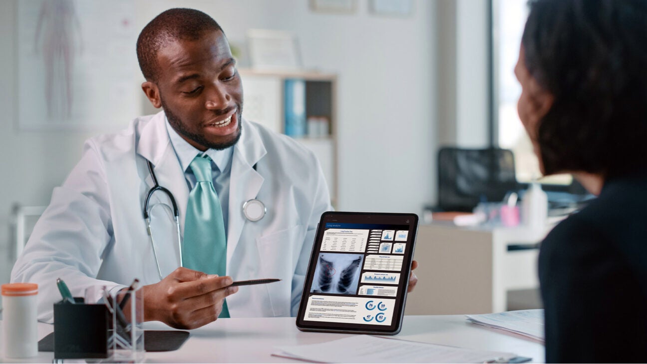 A doctor shows an image of a lung to a patient