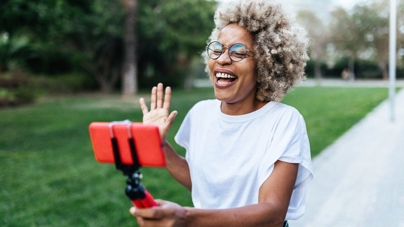 A woman talking animatedly on a phone.