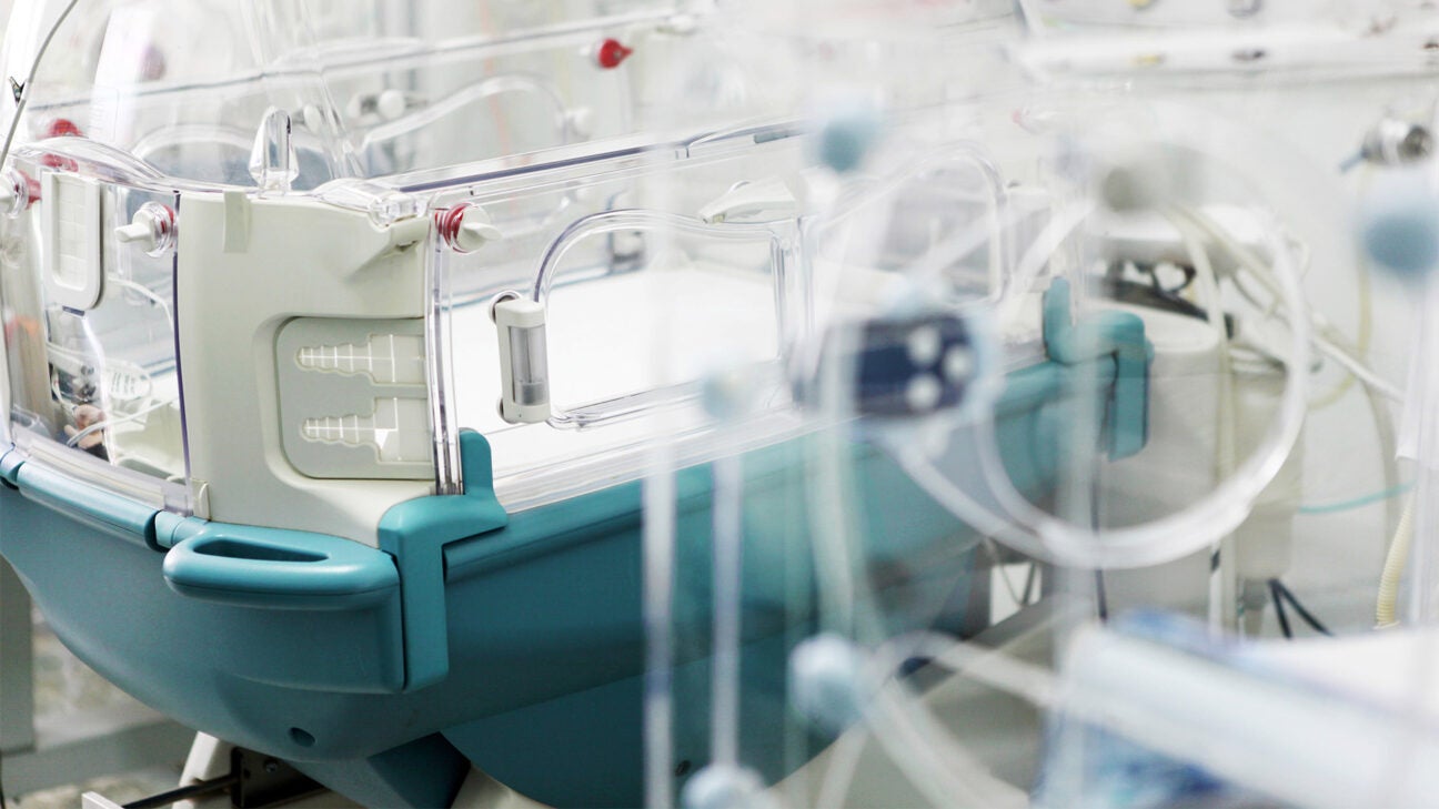 An empty incubator in a hospital NICU room