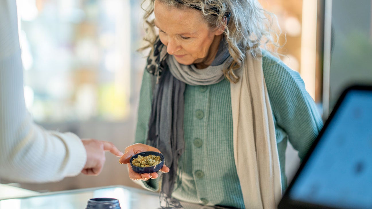 A woman looks at cannabis.