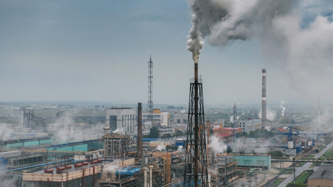 A smoke stack is seen at a distance.