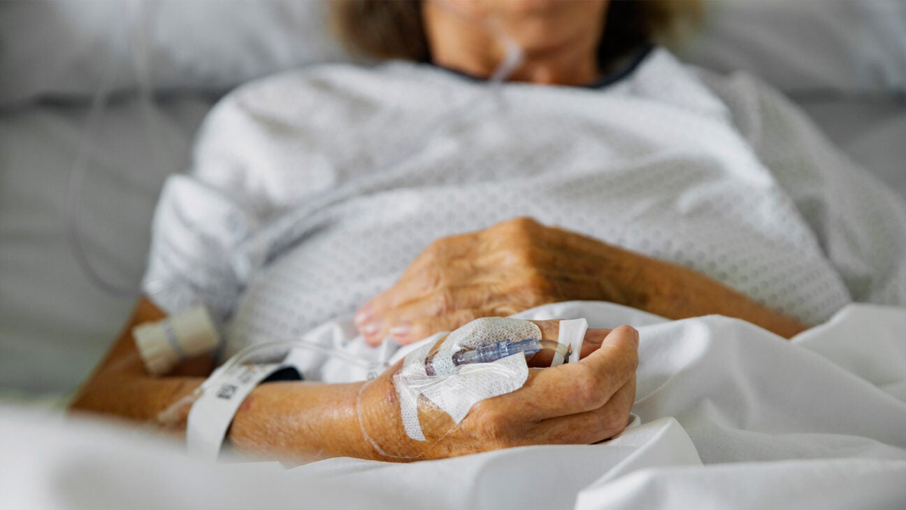 A woman is seen in a hospital bed.