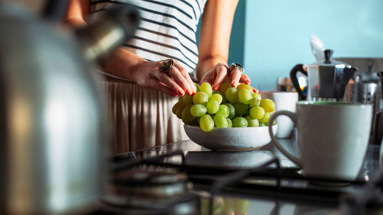 Female eats a bowl of flavonol-rich green grapes