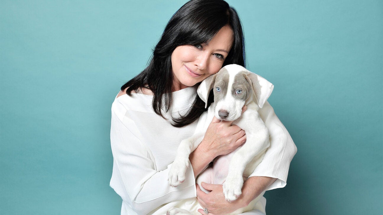 Shannen Doherty holding a puppy.