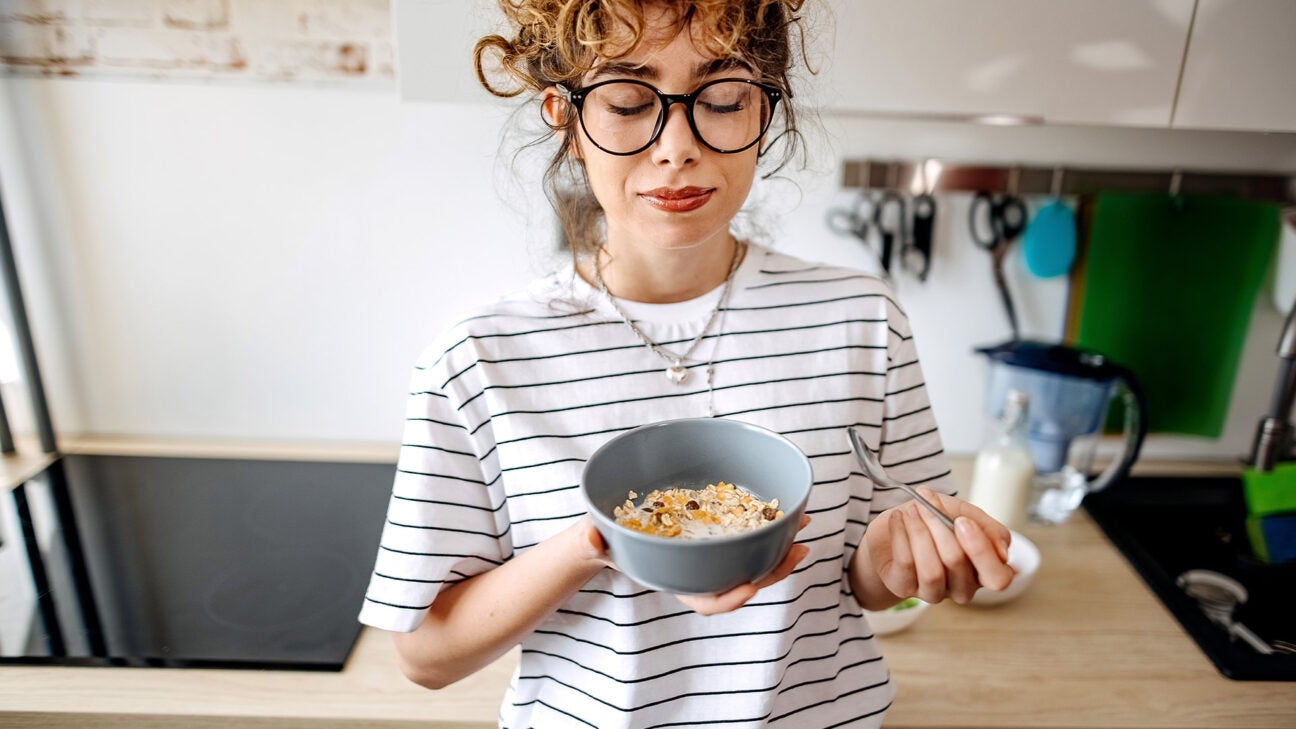 A woman eating cereal.