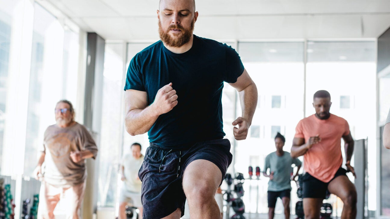 A man is seen working out in a gym.