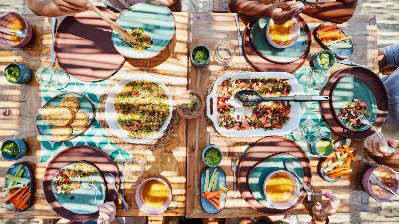 An overhead shot of people eating a vegetarian meal.