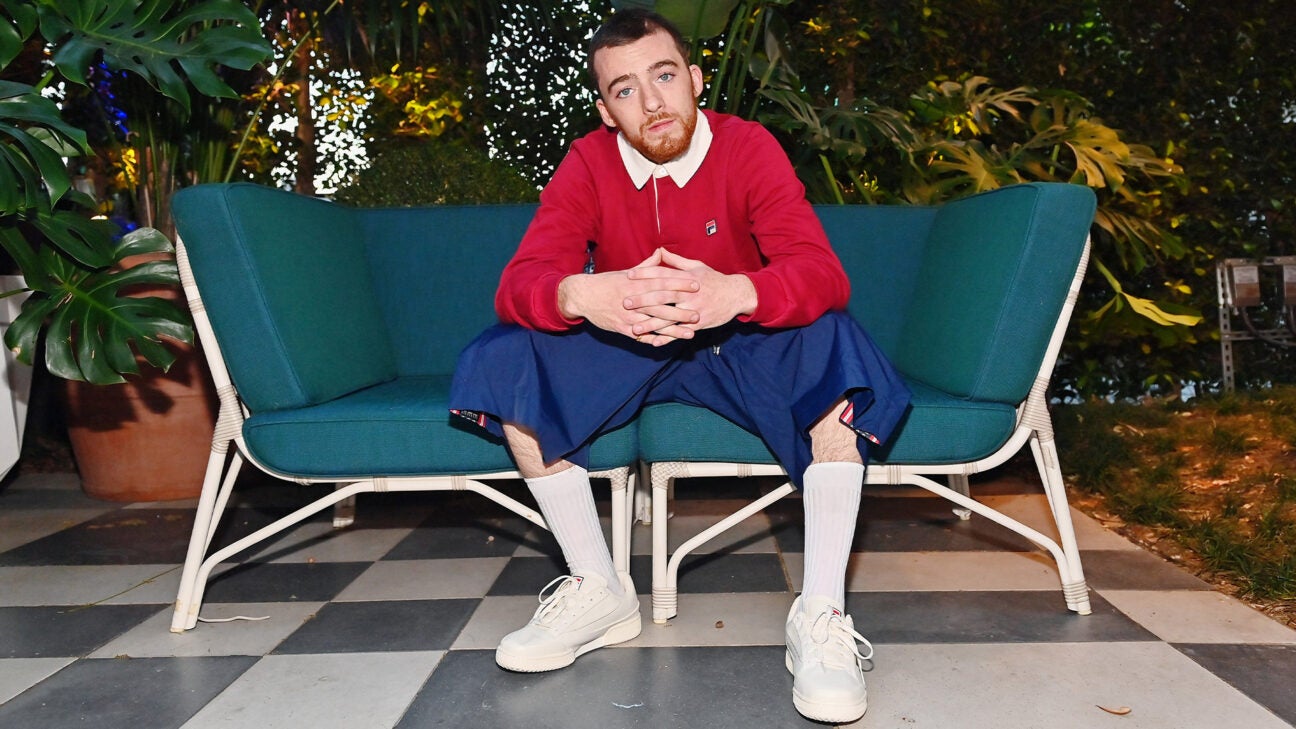 Actor Angus Cloud is seen sitting on sofa.