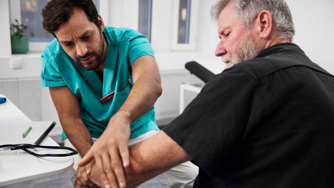 A healthcare worker helps a person in a clinic.